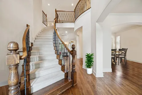 a view of entryway and hall with wooden floor