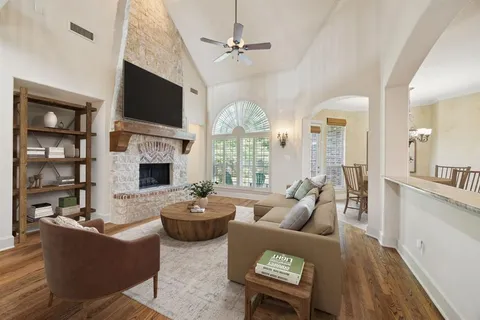 a living room with furniture fireplace and flat screen tv