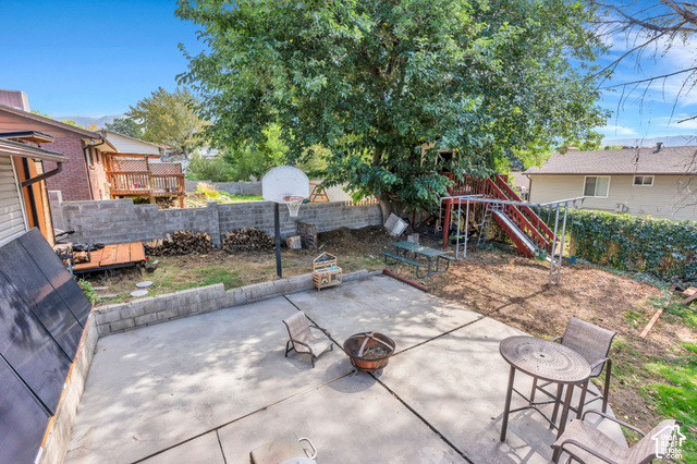 892 Bear Canyon Road Sandy, UT 84094 - Photo 29 of 36 Patio space with concrete surfacing, surrounding retaining walls, and mature trees