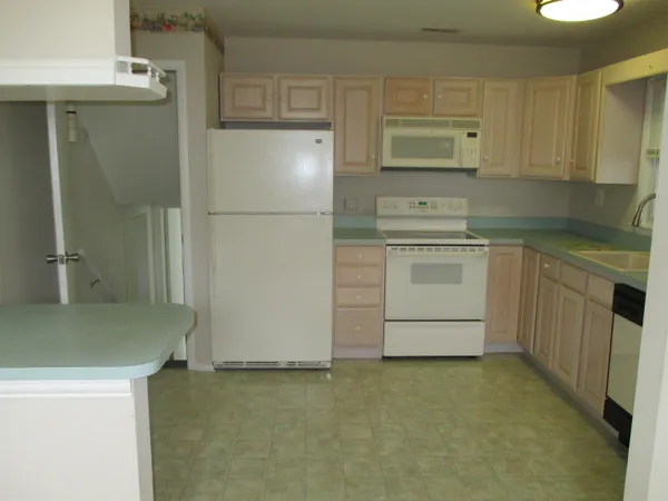 a kitchen with a sink stove and refrigerator