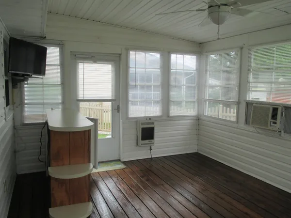 a view of a livingroom with furniture window and wooden floor