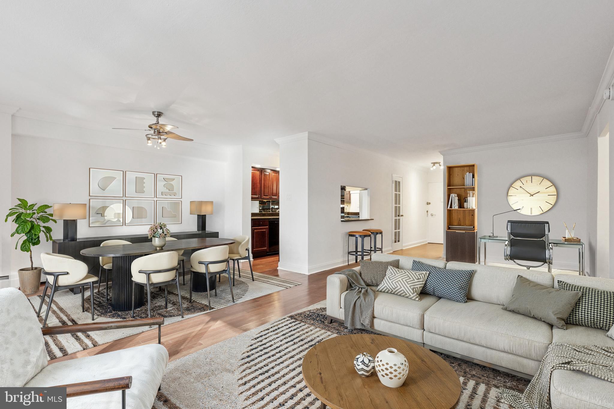 a living room with furniture a rug and a large window
