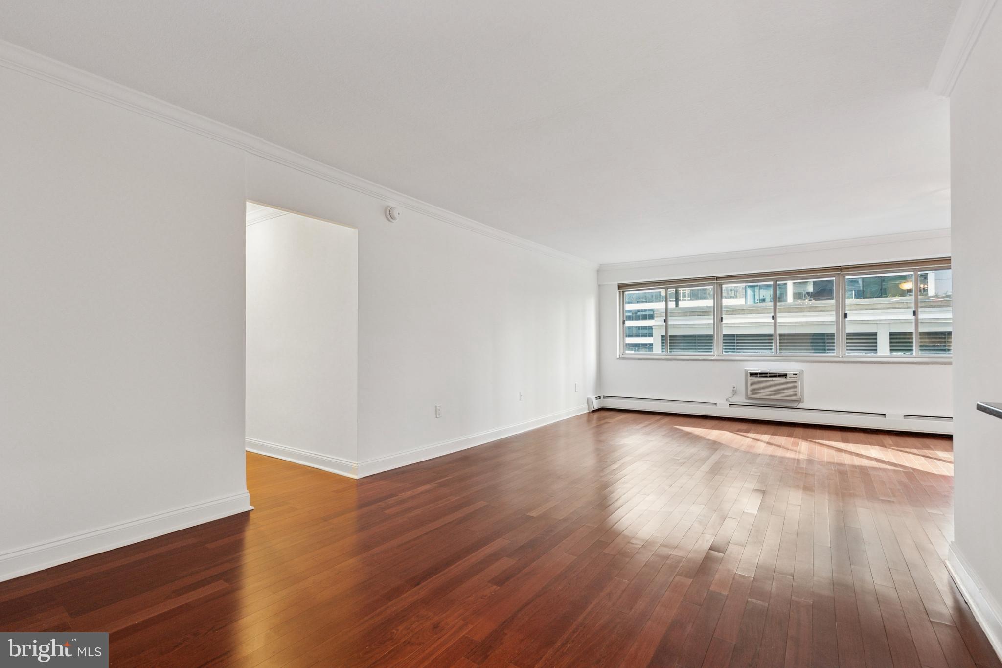 1900 John F Kennedy Boulevard, Unit 702 Philadelphia, PA 19103 - Photo 11 of 27 a view of an empty room with wooden floor and a window
