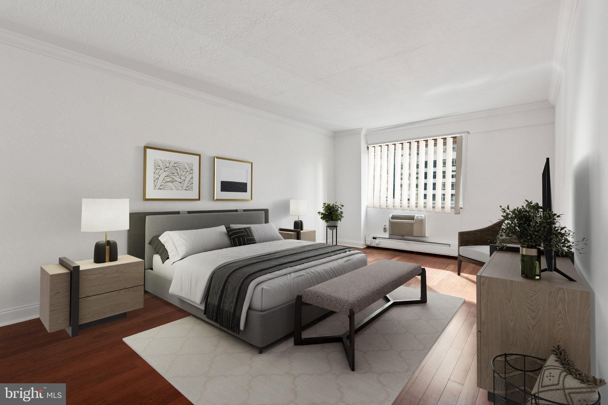 1900 John F Kennedy Boulevard, Unit 702 Philadelphia, PA 19103 - Photo 15 of 27 a spacious bedroom with a bed and a couch