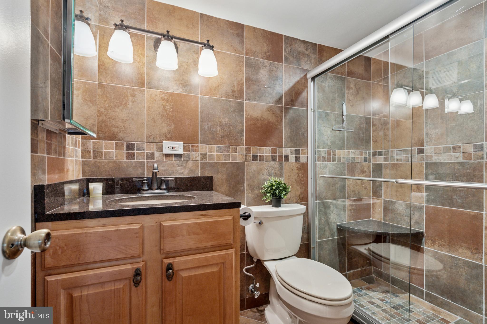 1900 John F Kennedy Boulevard, Unit 702 Philadelphia, PA 19103 - Photo 17 of 27 a bathroom with a toilet a sink and shower
