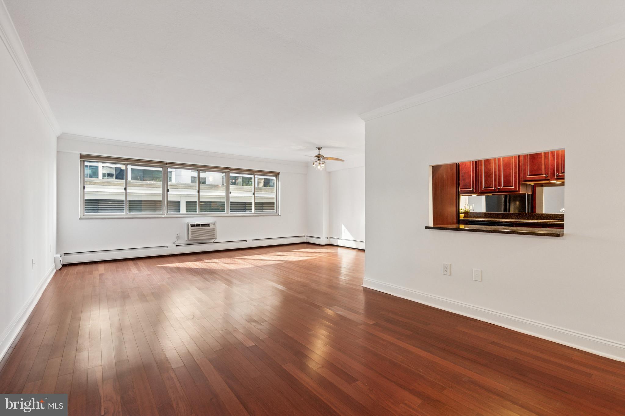1900 John F Kennedy Boulevard, Unit 702 Philadelphia, PA 19103 - Photo 4 of 27 an empty room with wooden floor and windows