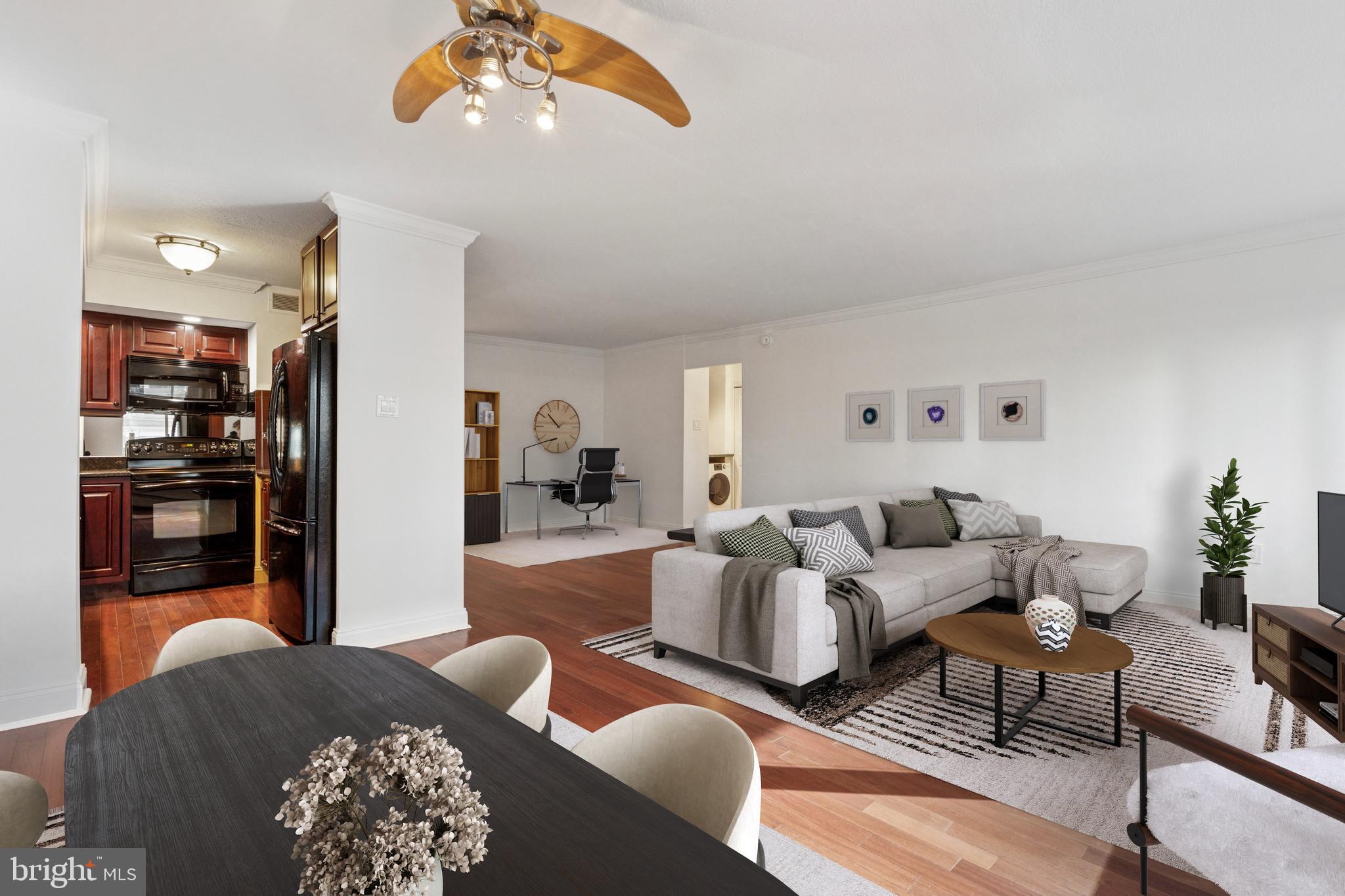 1900 John F Kennedy Boulevard, Unit 702 Philadelphia, PA 19103 - Photo 5 of 27 a living room with furniture a chandelier and a rug
