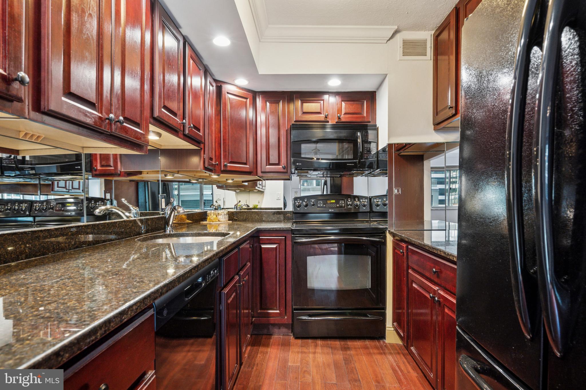 1900 John F Kennedy Boulevard, Unit 702 Philadelphia, PA 19103 - Photo 7 of 27 a kitchen with stainless steel appliances granite countertop a stove a refrigerator and a stove