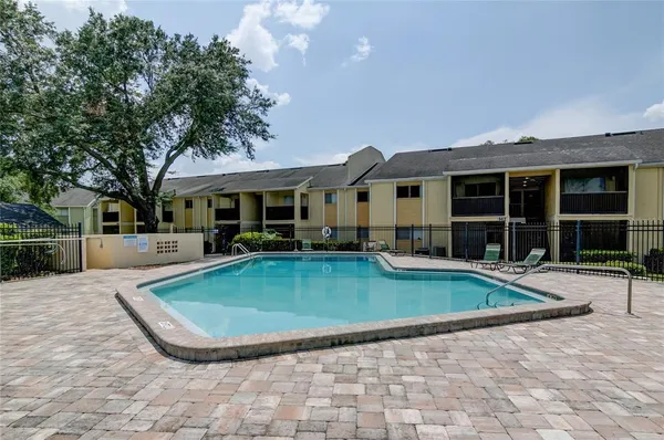 a view of a house with swimming pool and sitting area