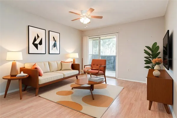 a living room with furniture a chandelier and a window