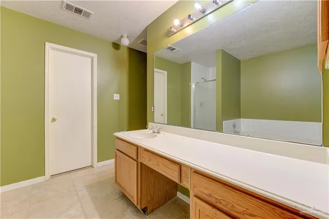 a bathroom with a sink a mirror and a bathtub