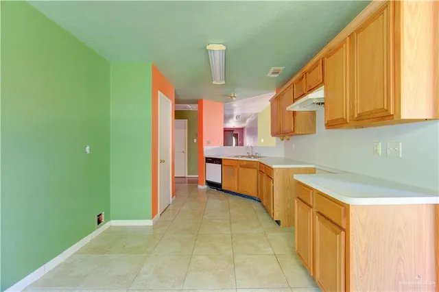 a kitchen with stainless steel appliances granite countertop a sink and cabinets