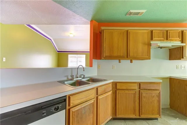 a kitchen with a sink and cabinets