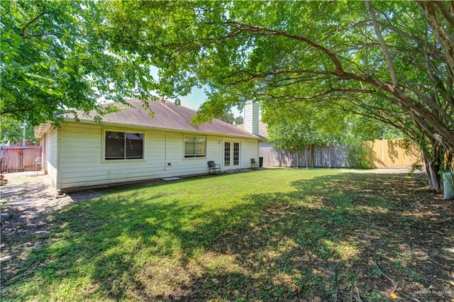 a front view of a house with yard and tree