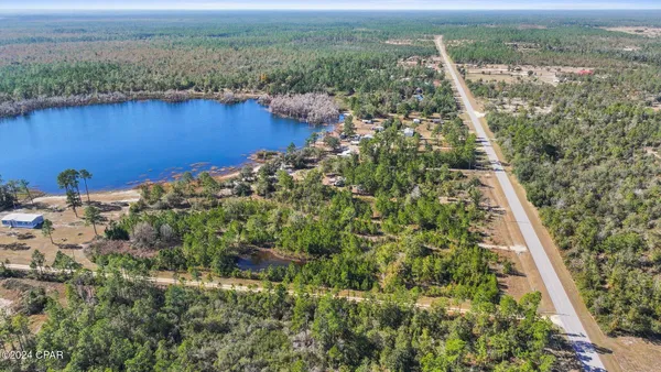 view of a lake with a yard