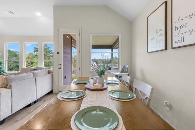 a dining room with furniture wooden floor and a rug