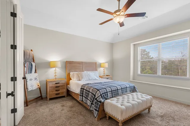 a bedroom with a bed and a window