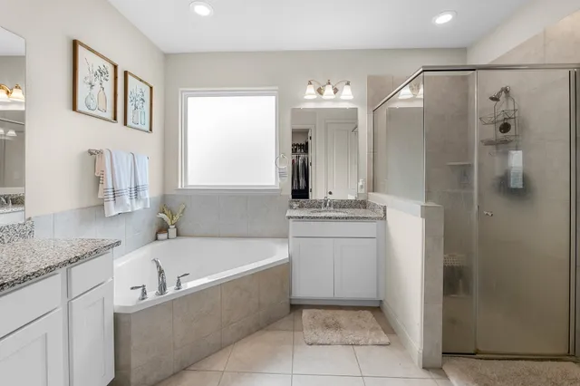 a bathroom with a bathtub sink and mirror