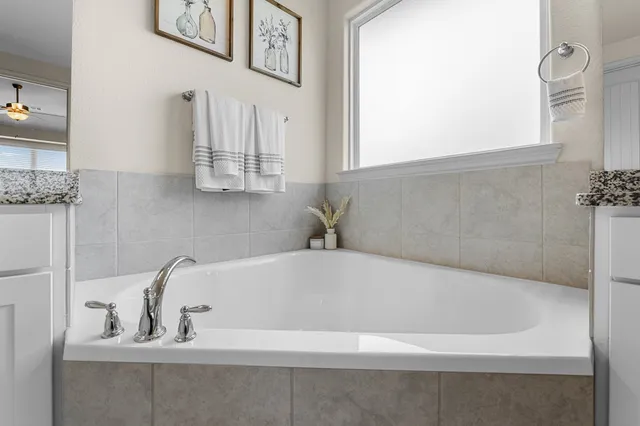 a white bath tub sitting in a bathroom