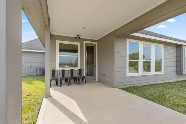 a swimming pool with outdoor seating and yard