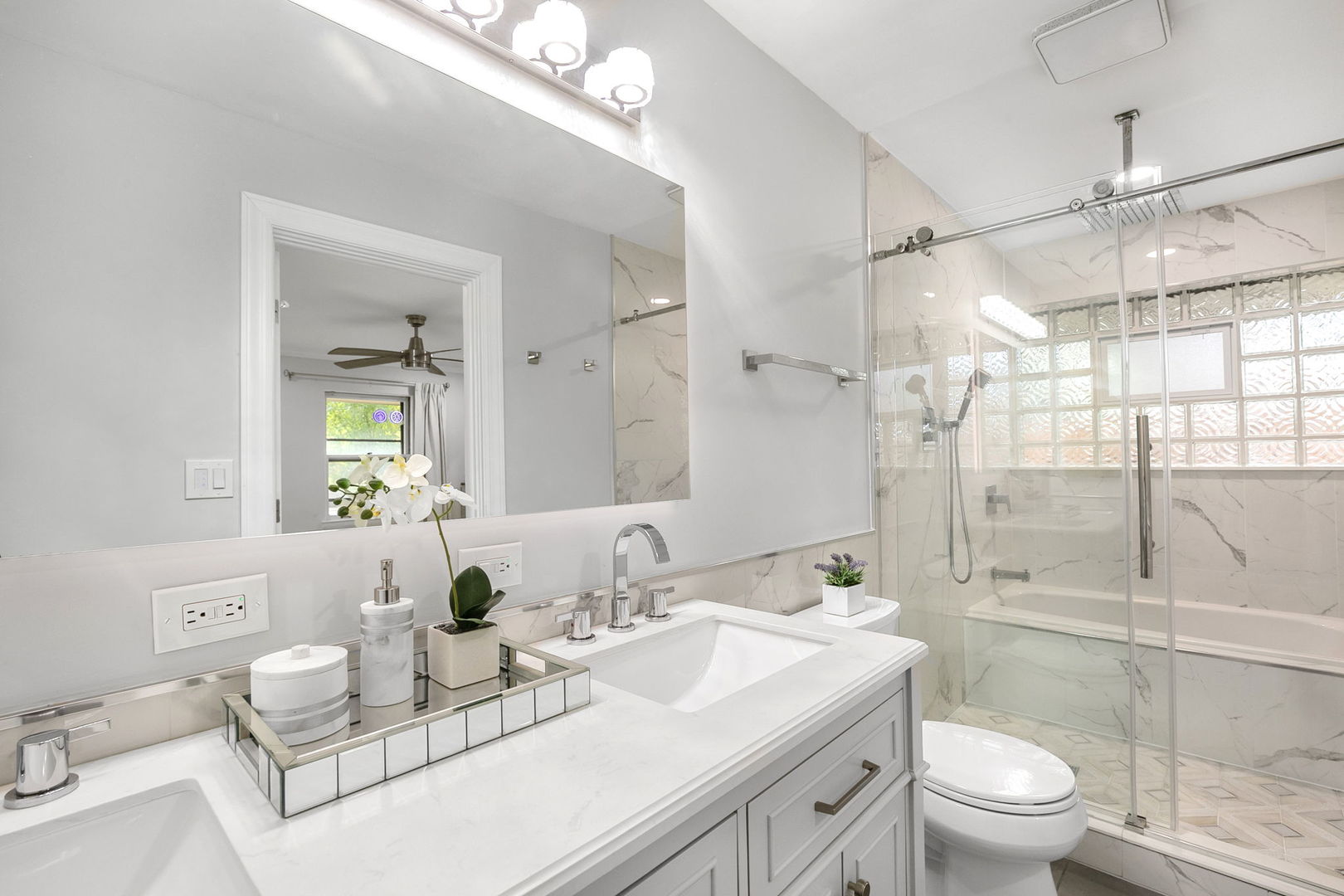 124 West Old Elm Road Lake Forest, IL 60045 - Photo 18 of 31 a bathroom with a granite countertop sink a toilet and shower