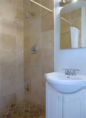 a bathroom with a sink a mirror and a shower