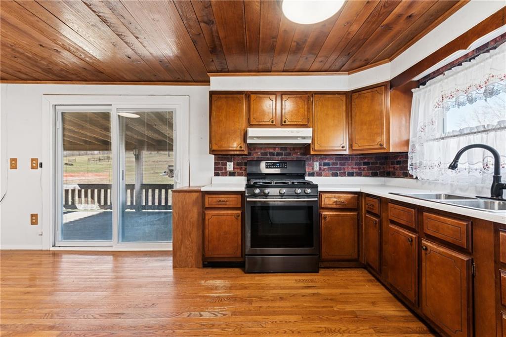 3323 State Rte 2011 Scenery Hill, PA 15360 - Photo 12 of 34 a kitchen with stainless steel appliances granite countertop a stove a sink and a microwave