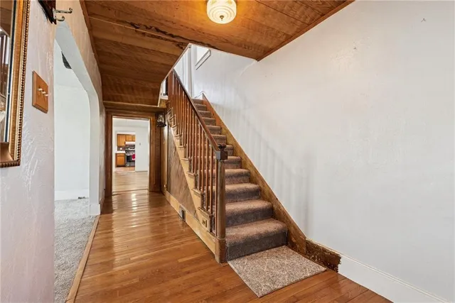a view of a room with wooden floor