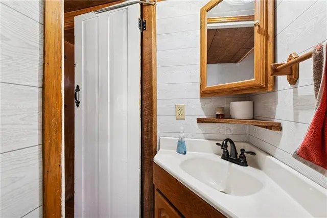 a room with a table a sink and a refrigerator