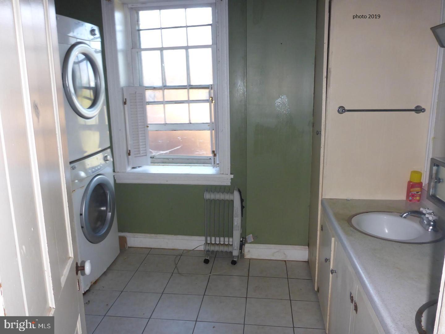 63 Money Island Road Salem, NJ 08079 - Photo 29 of 41 a bathroom with a sink a washer and dryer