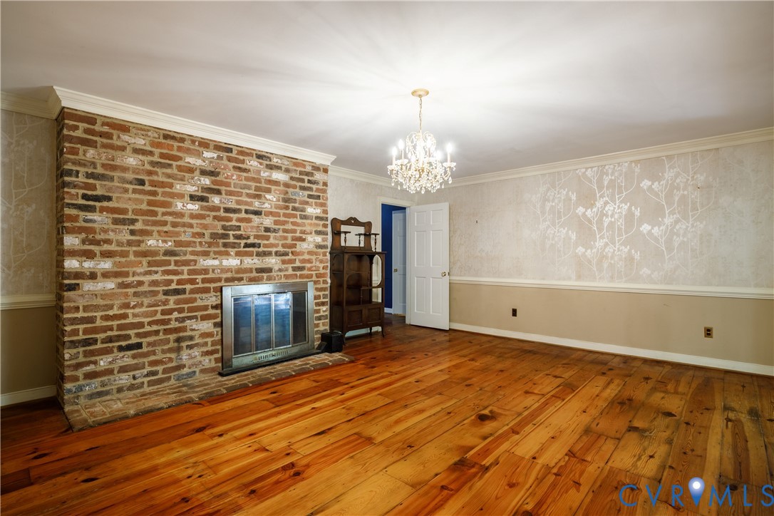 10760 Cherokee Road Midlothian, VA 23113 - Photo 15 of 43 a view of a livingroom with wooden floor and a fireplace