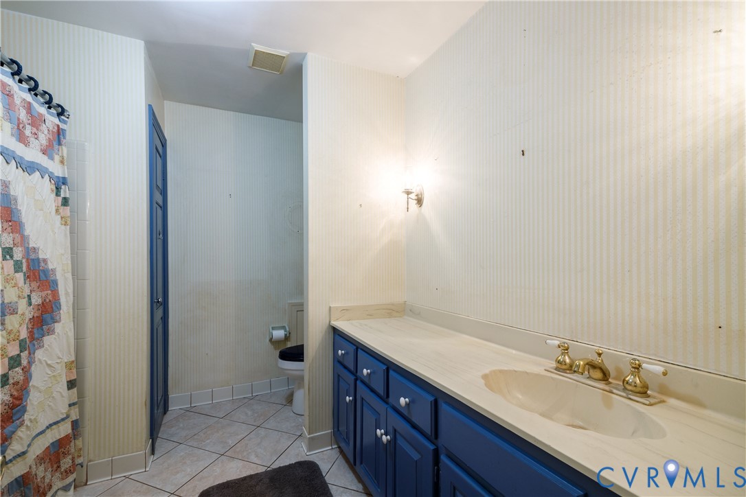 10760 Cherokee Road Midlothian, VA 23113 - Photo 27 of 43 a bathroom with a granite countertop sink and a mirror