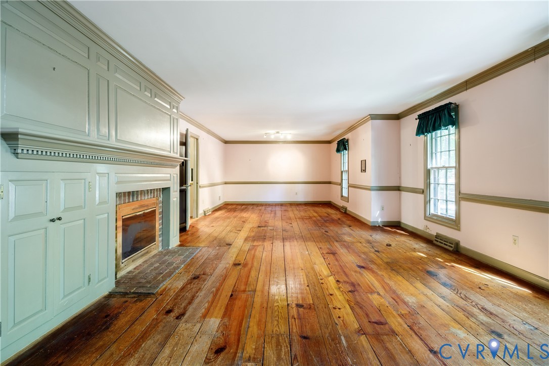 10760 Cherokee Road Midlothian, VA 23113 - Photo 6 of 43 a view of empty room with wooden floor and fireplace