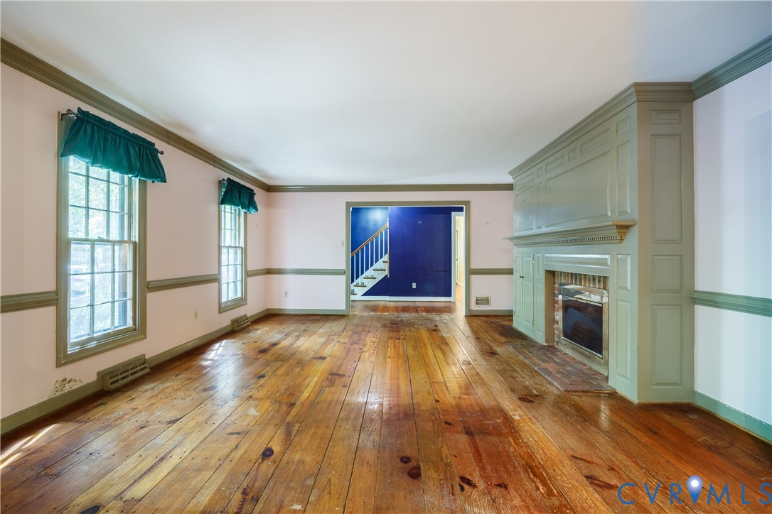 10760 Cherokee Road Midlothian, VA 23113 - Photo 8 of 43 wooden floor fireplace and windows in an empty room