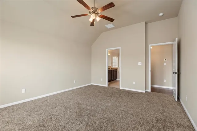 an empty room with closet and a chandelier fan