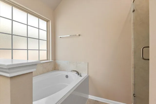 a bathroom with a bathtub and window