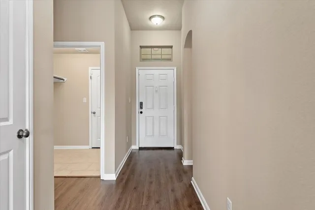 a view of hallway with wooden floor