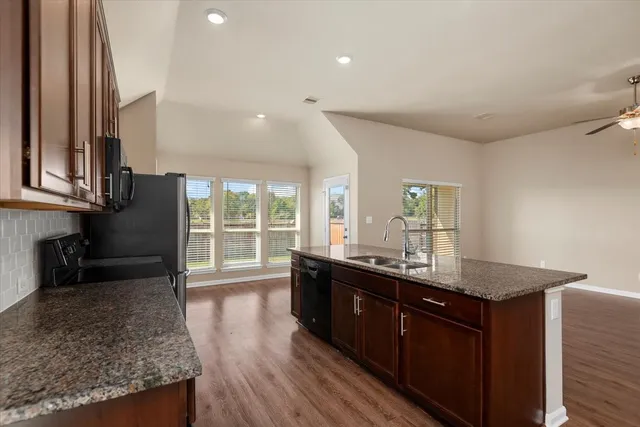 a kitchen with granite countertop a sink and a counter top space