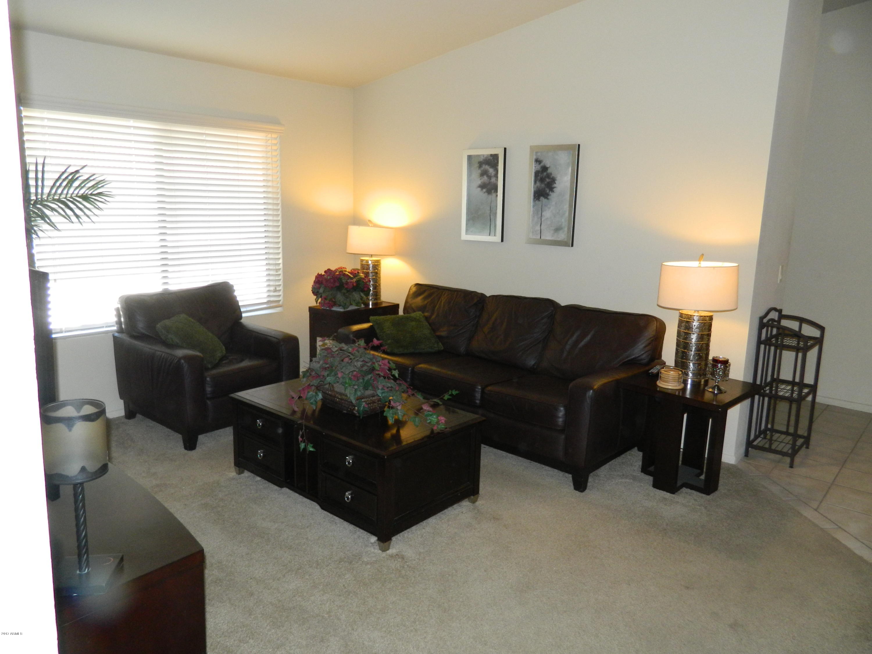 1402 East Guadalupe Road, Unit 245 Tempe, AZ 85283 - Photo 12 of 29 a living room with furniture and a lamp