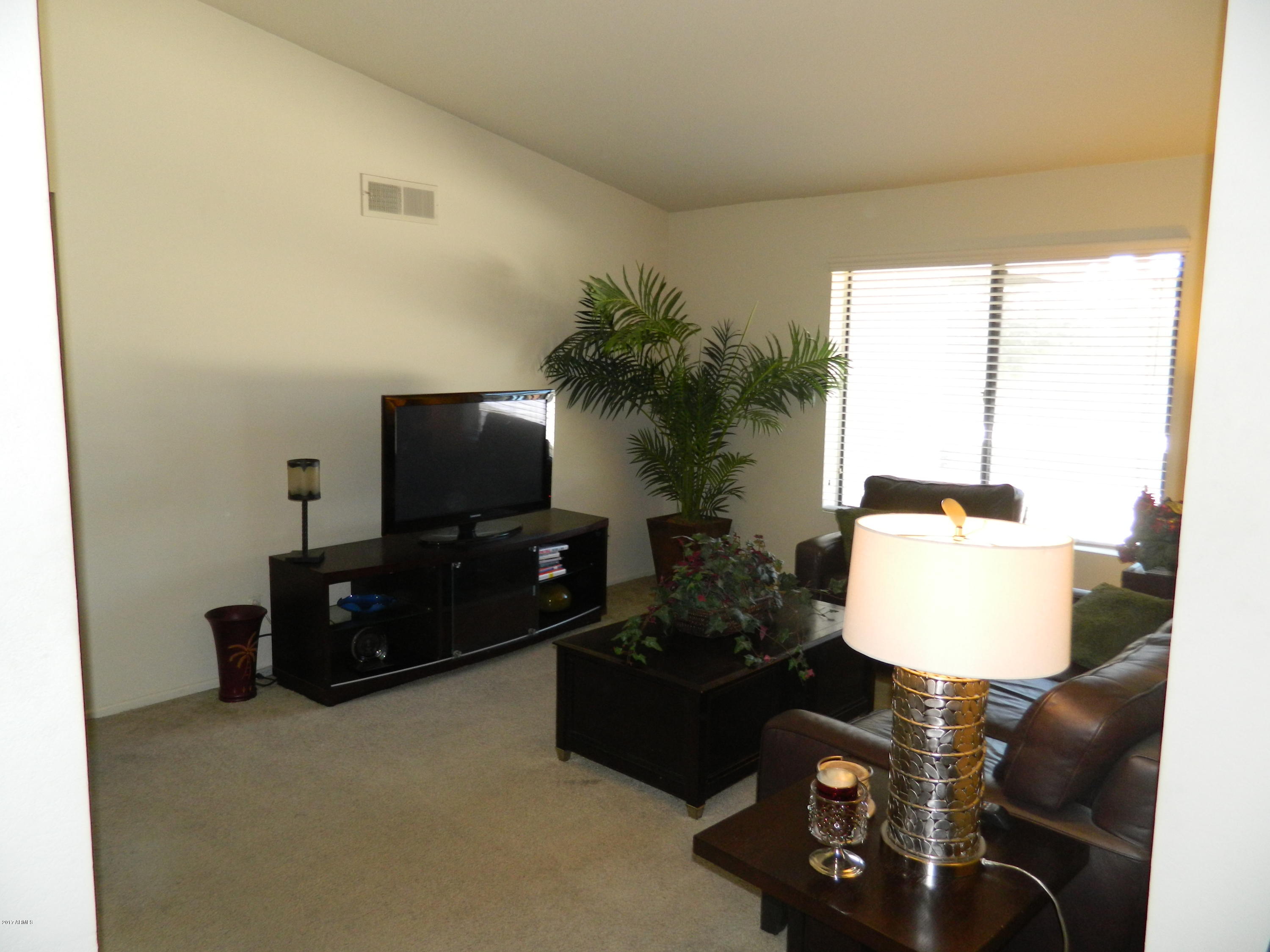 1402 East Guadalupe Road, Unit 245 Tempe, AZ 85283 - Photo 13 of 29 a living room with furniture and a flat screen tv