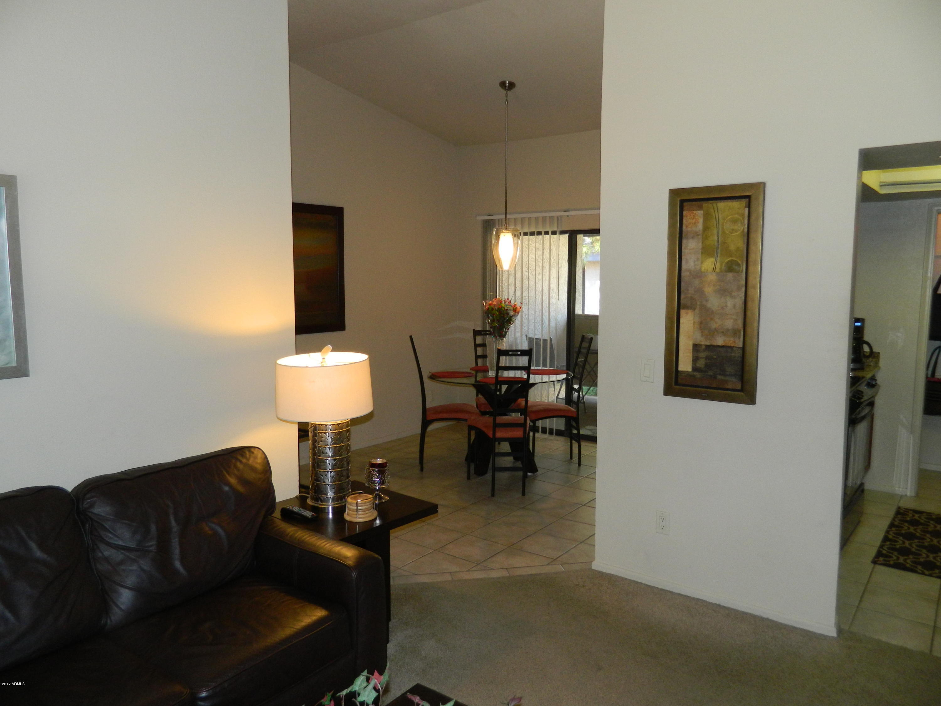1402 East Guadalupe Road, Unit 245 Tempe, AZ 85283 - Photo 14 of 29 a living room with furniture a lamp and a window