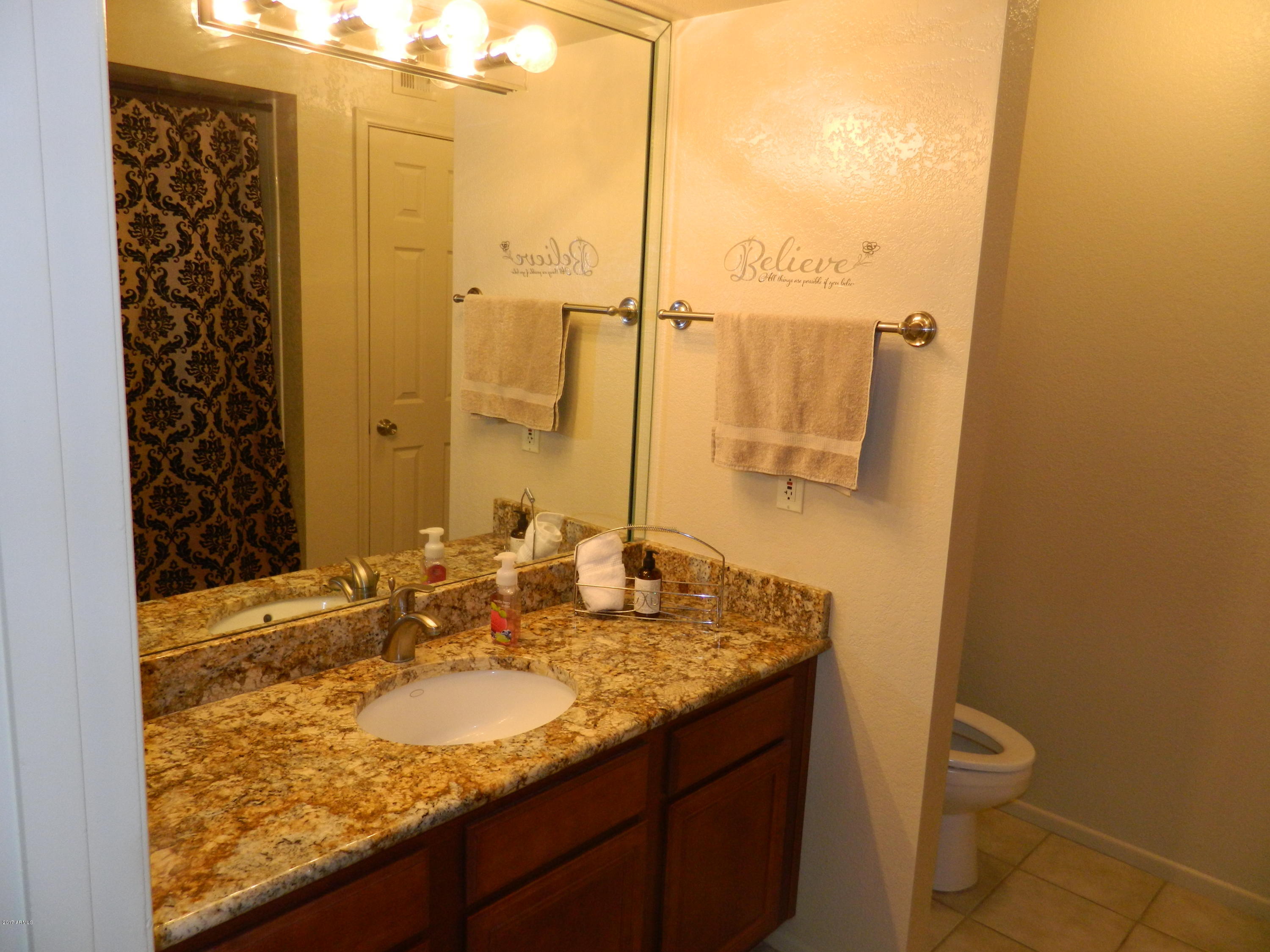 1402 East Guadalupe Road, Unit 245 Tempe, AZ 85283 - Photo 17 of 29 a bathroom with a granite countertop sink and a mirror