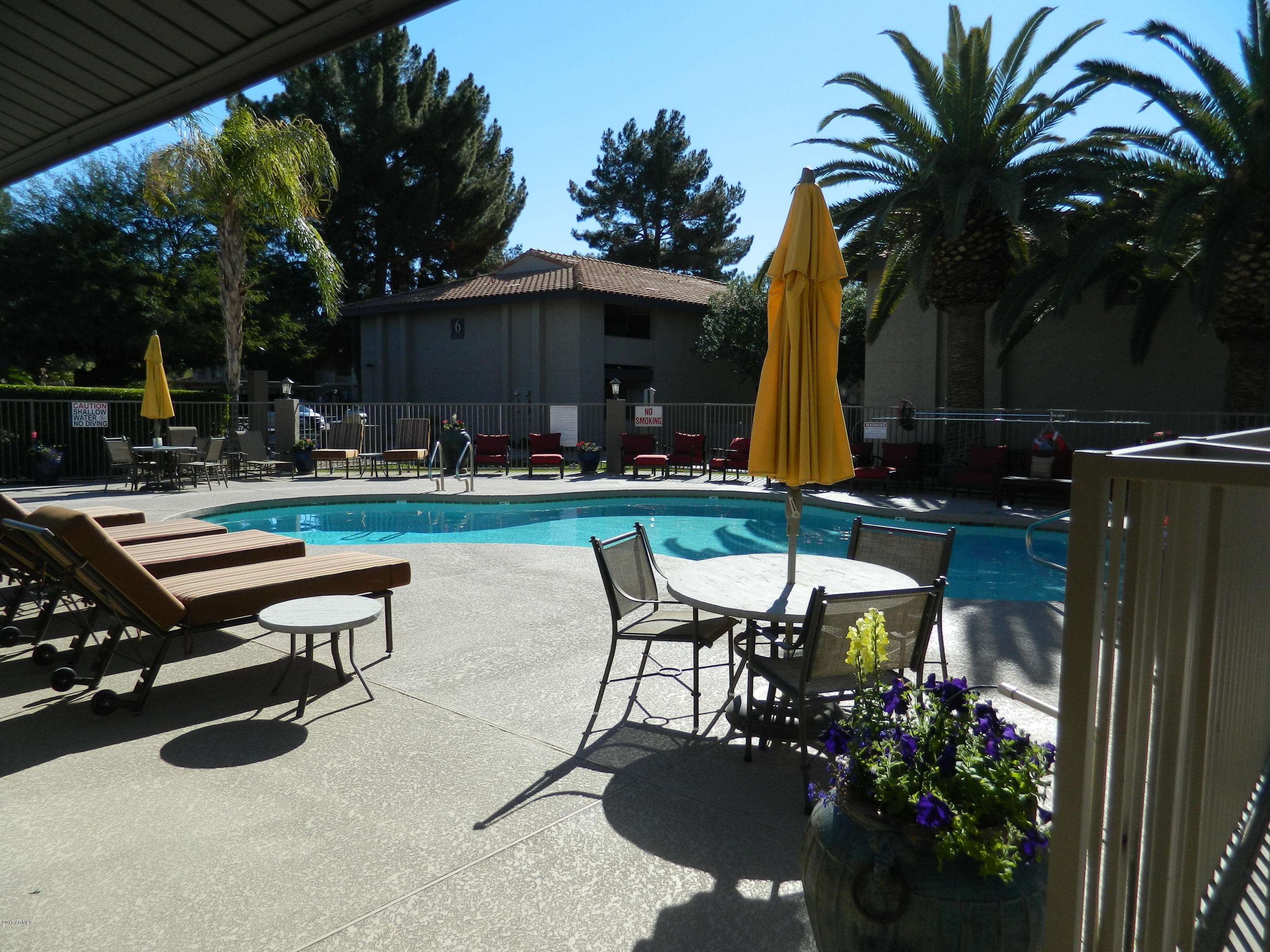 1402 East Guadalupe Road, Unit 245 Tempe, AZ 85283 - Photo 25 of 29 a swimming pool with outdoor seating and yard