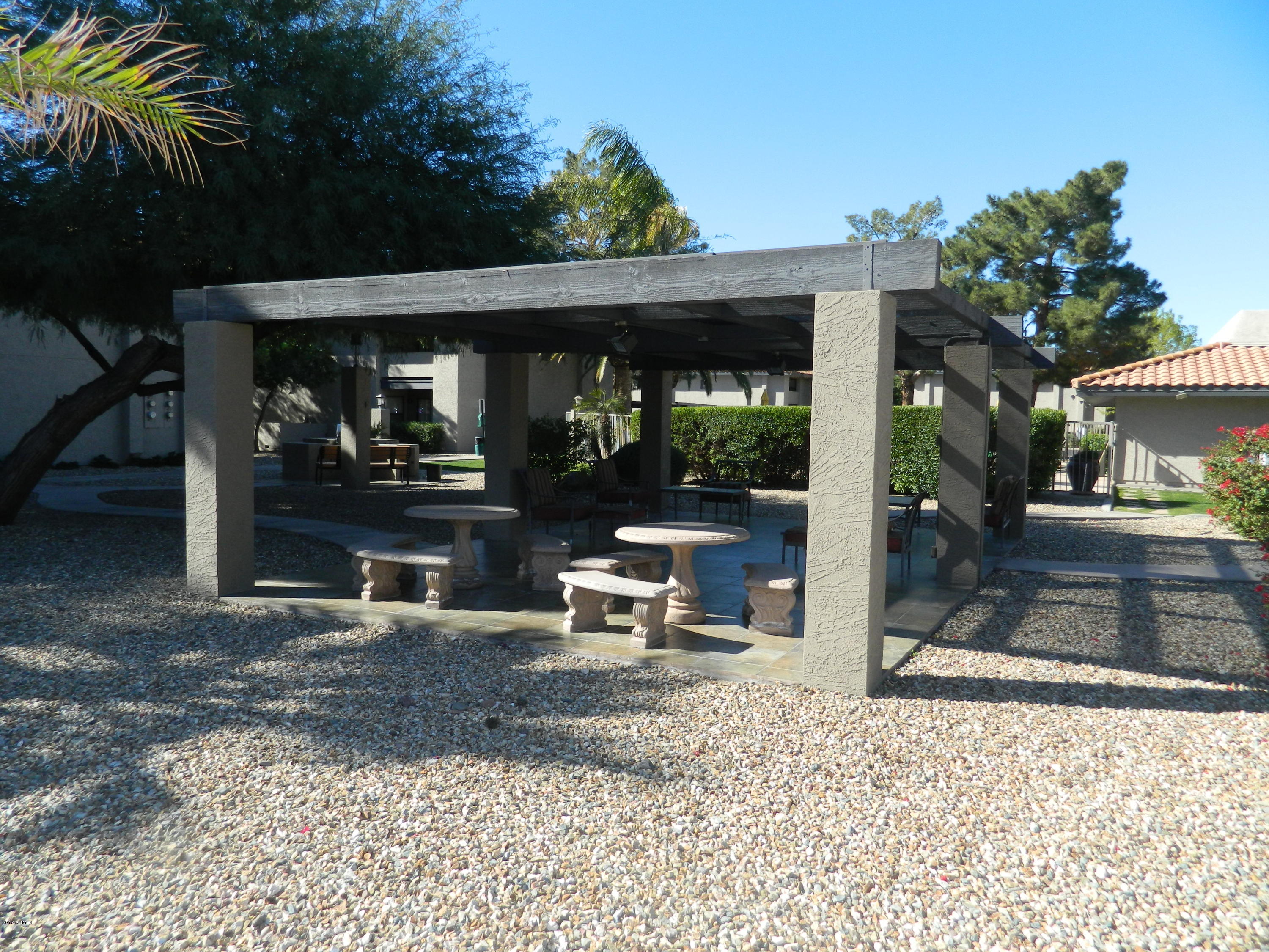 1402 East Guadalupe Road, Unit 245 Tempe, AZ 85283 - Photo 28 of 29 a view of a patio with a table and chairs under an umbrella