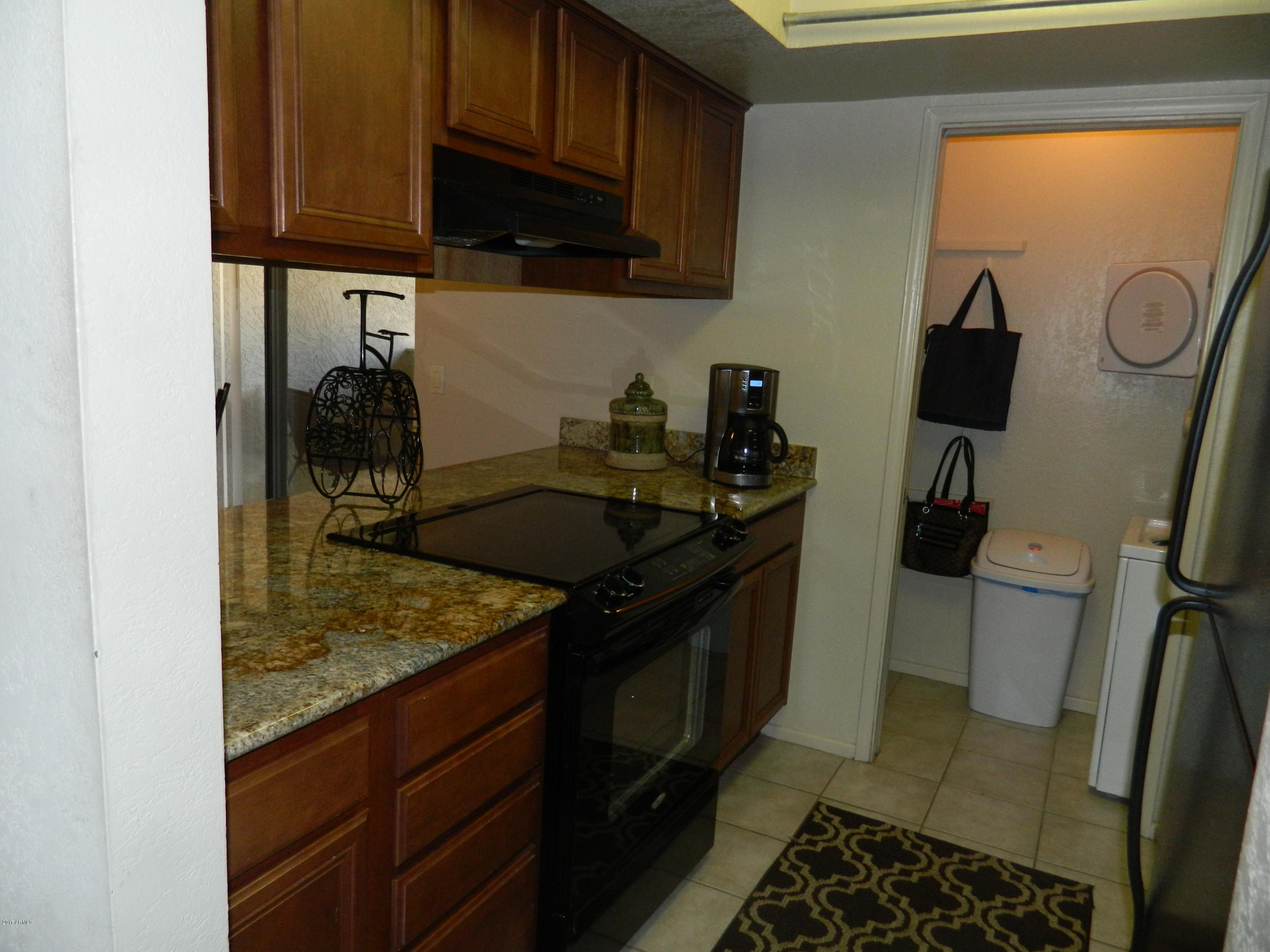 1402 East Guadalupe Road, Unit 245 Tempe, AZ 85283 - Photo 9 of 29 a kitchen with a sink and cabinets