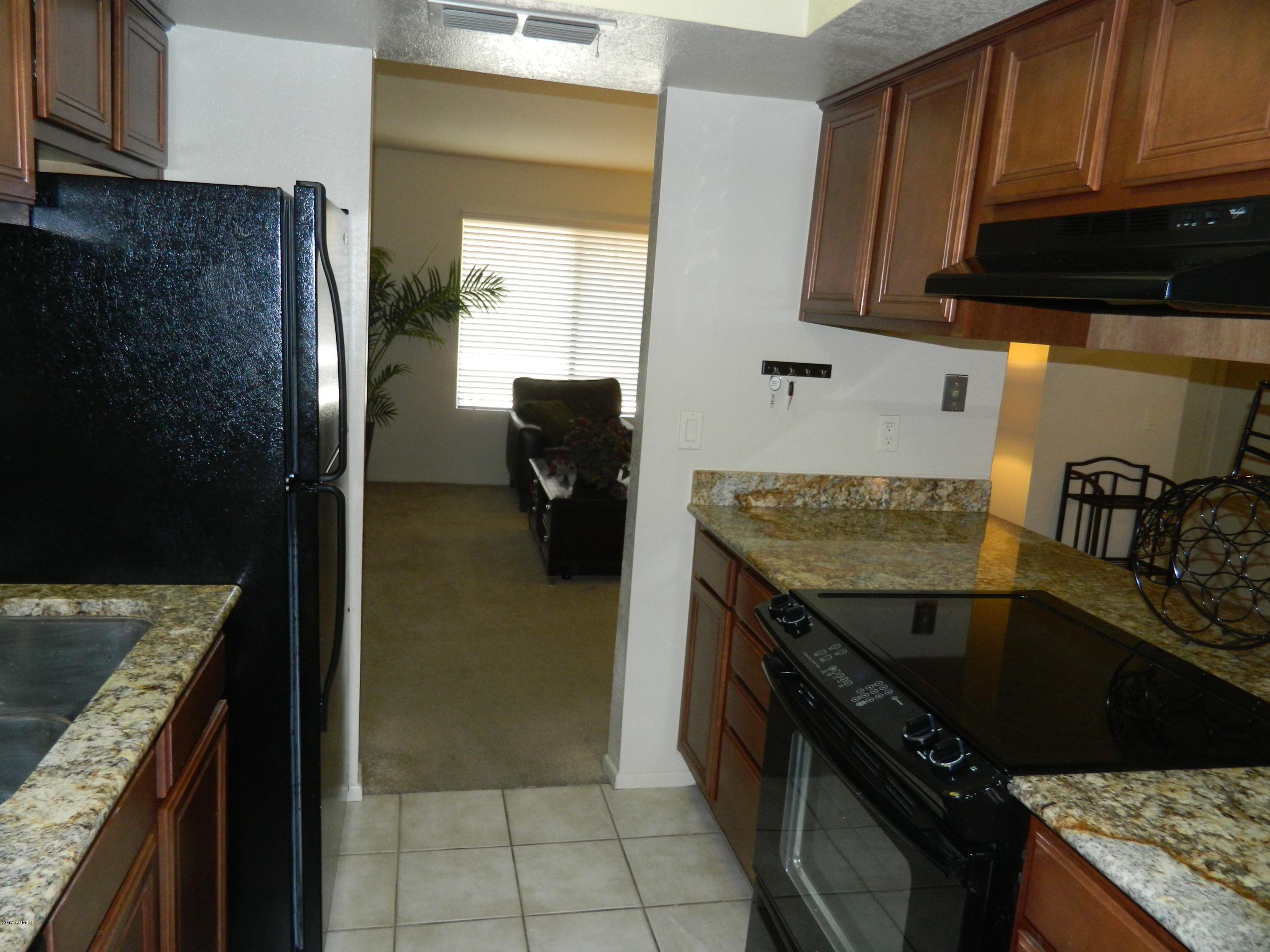 1402 East Guadalupe Road, Unit 245 Tempe, AZ 85283 - Photo 10 of 29 a kitchen with a sink stove and refrigerator