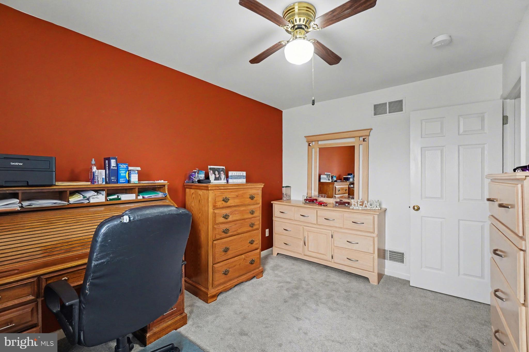 8636 Winding Way Perry Hall, MD 21128 - Photo 15 of 40 a bedroom with a dresser and a ceiling fan