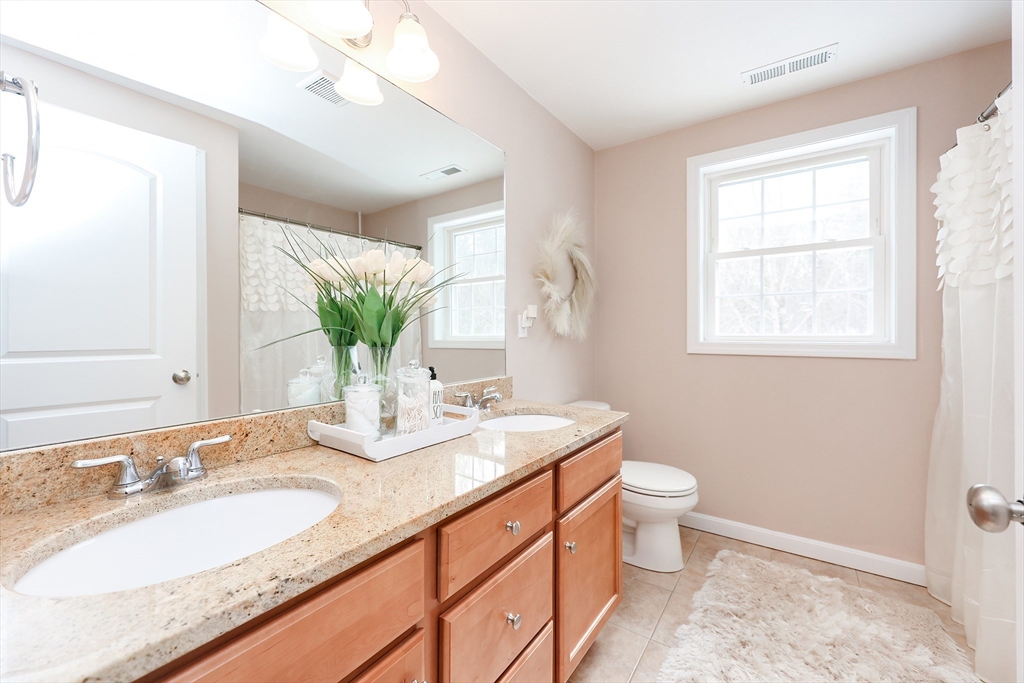 31 Bufton Farm Road Clinton, MA 01510 - Photo 23 of 37 a bathroom with a granite countertop sink mirror and a toilet