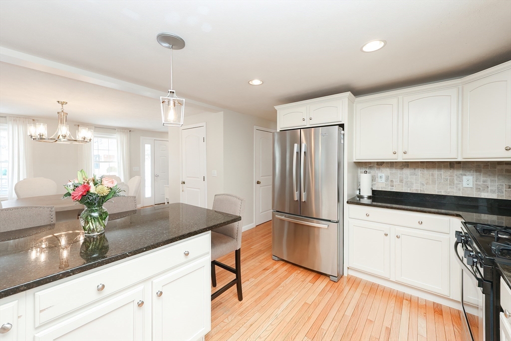31 Bufton Farm Road Clinton, MA 01510 - Photo 7 of 37 a kitchen with granite countertop a refrigerator a sink dishwasher and white cabinets with wooden floor
