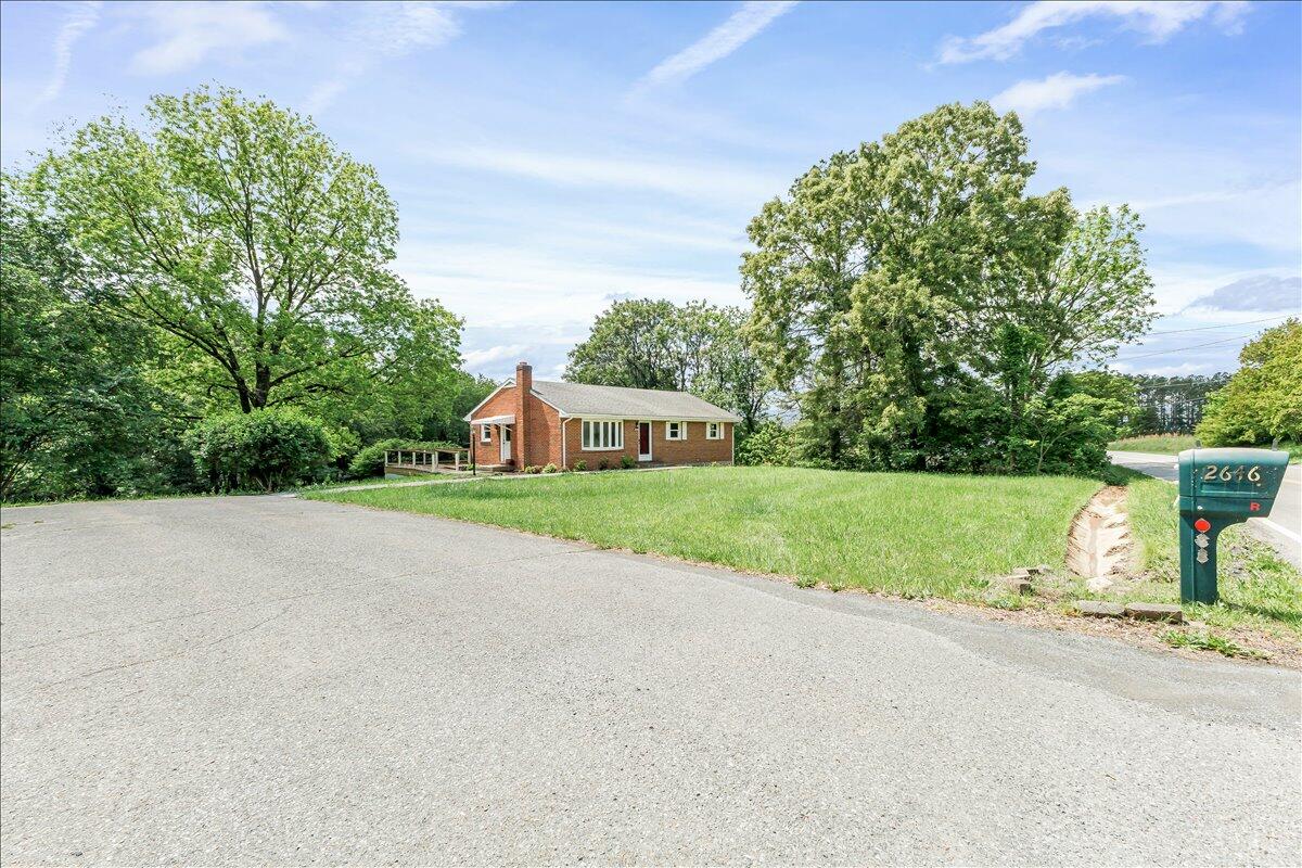 2646 Dickerson Mill Road Bedford, VA 24523 - Photo 45 of 46 a view of a house with a yard and large trees